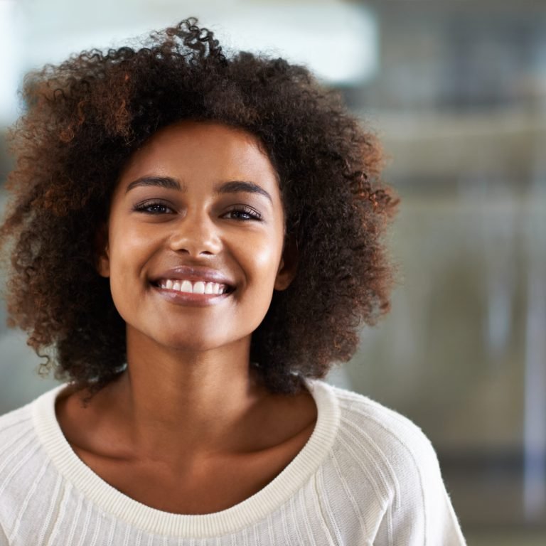Portrait of a smiling young woman at home.